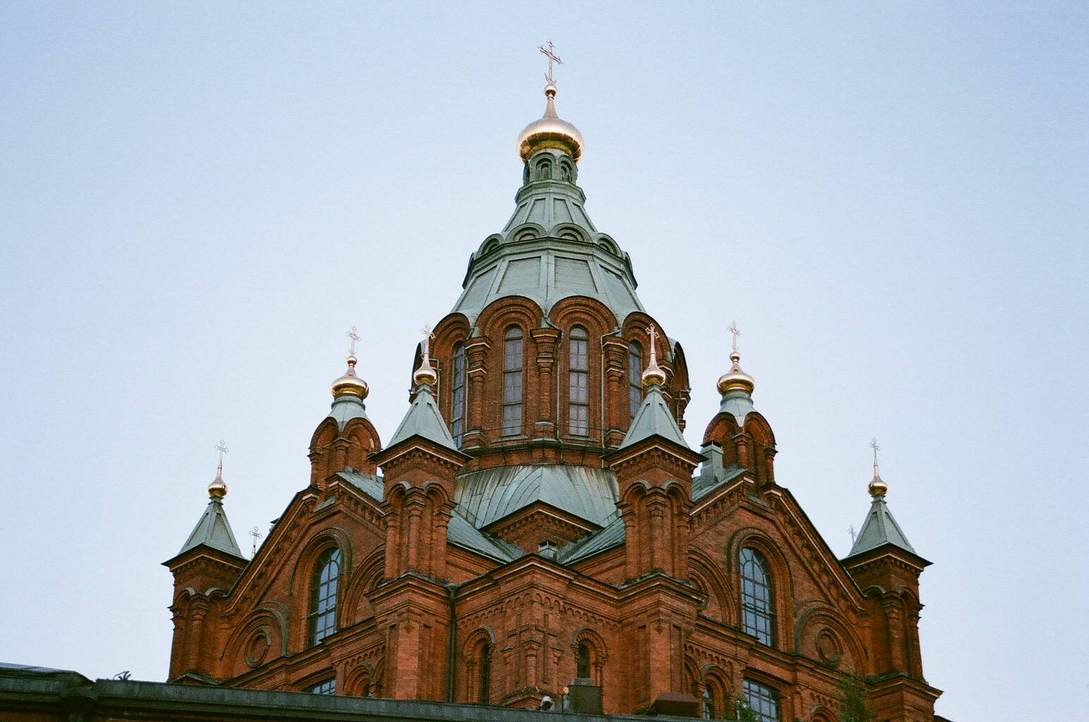 symmetrical view of a red brick coloured cathedral under the blue sky
