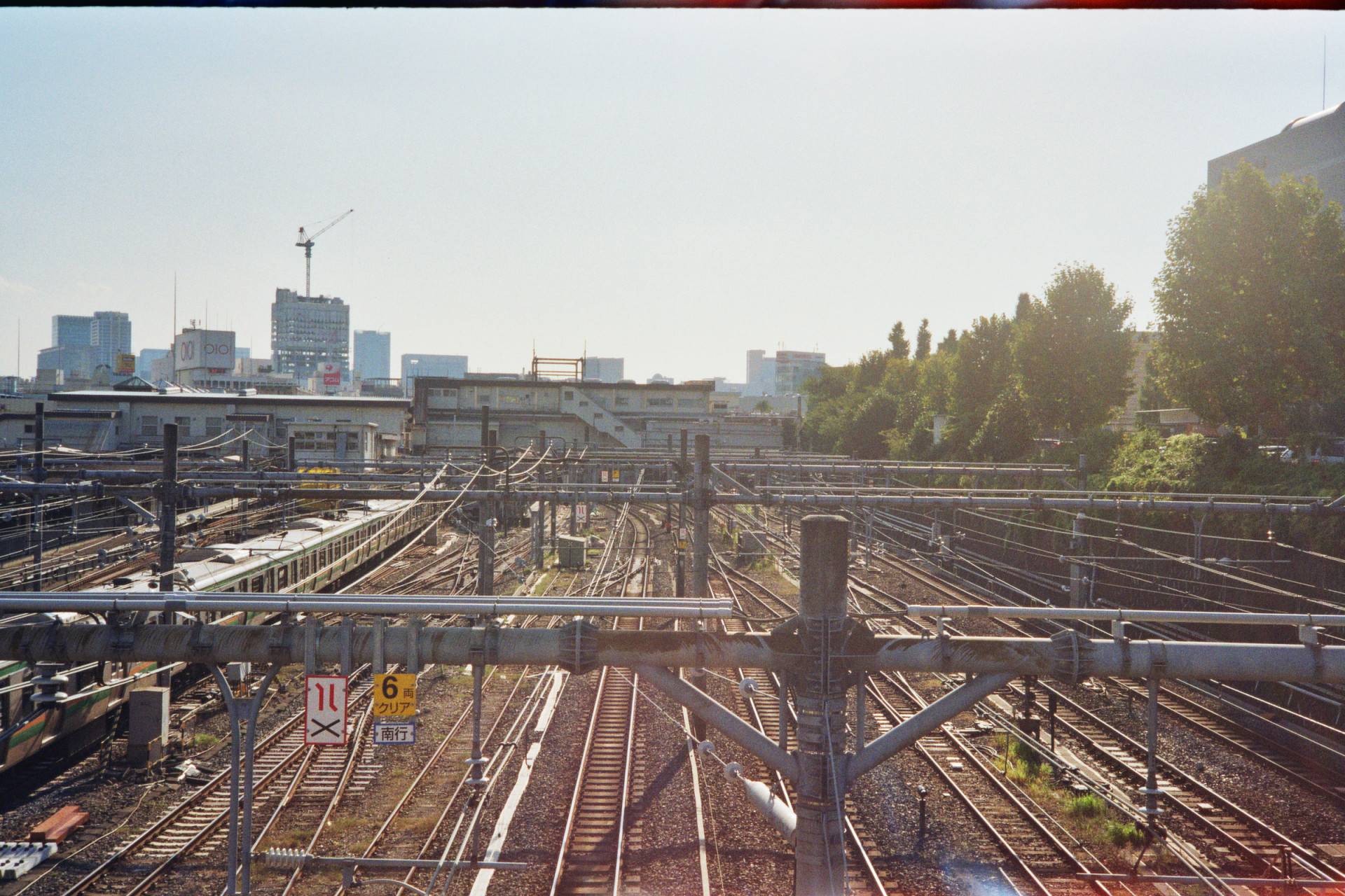 an overview of the train tracks and the pipe network on top of it around the train station shot under the bright open sky