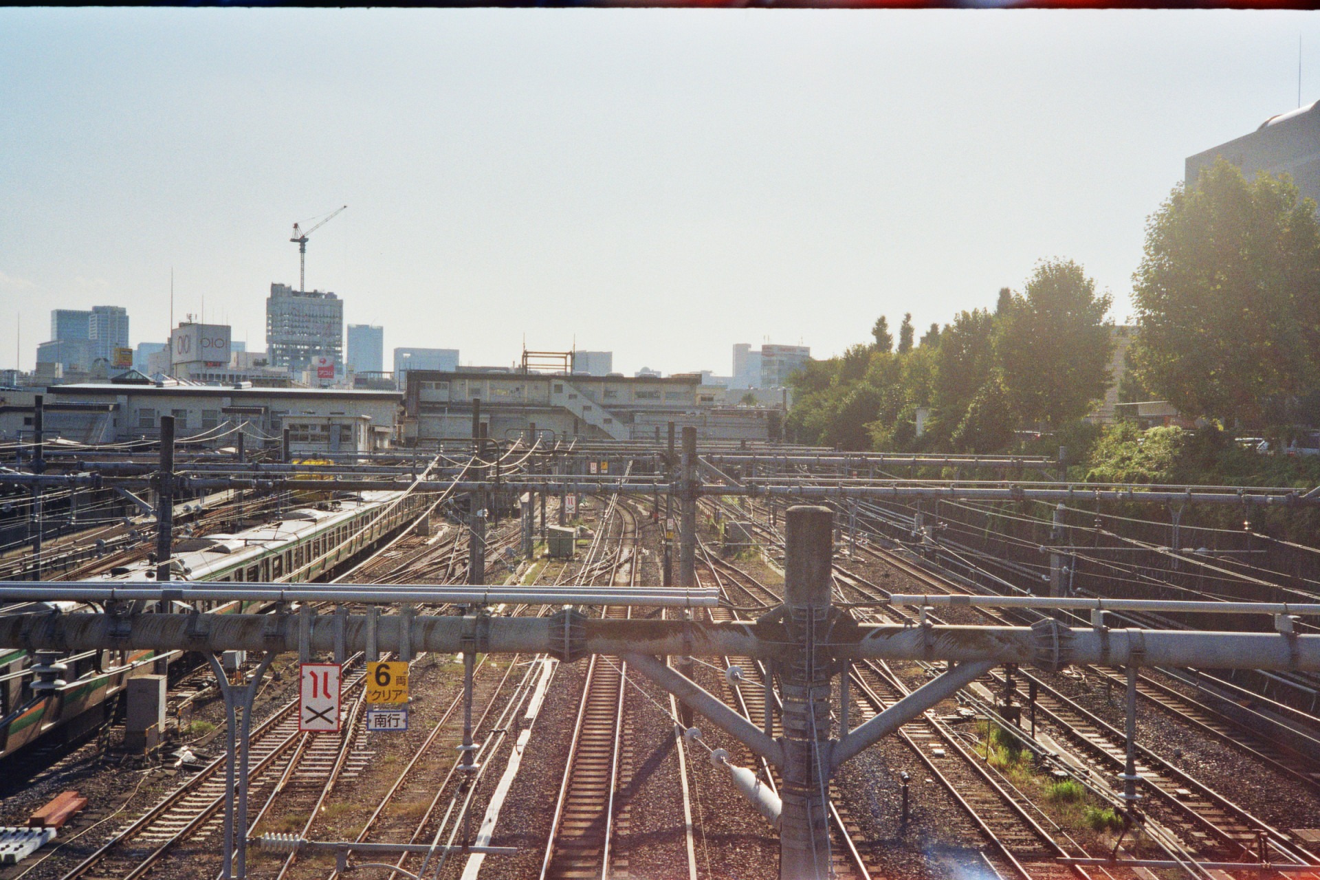 an overview of the train tracks and the pipe network on top of it around the train station shot under the bright open sky